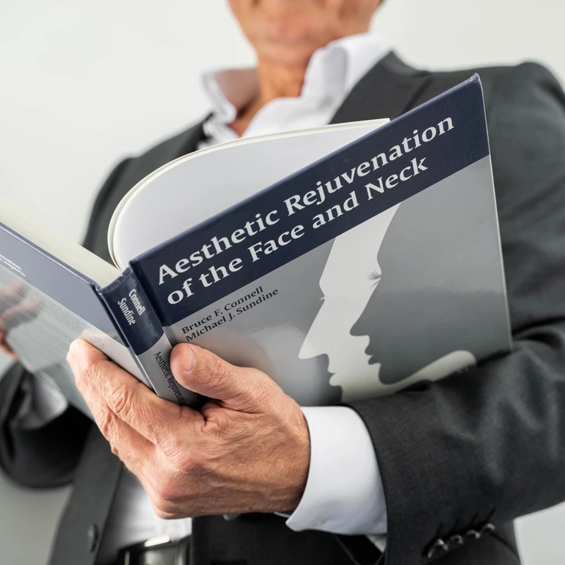 Dr. Sundine holding book